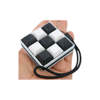 Picky Clicky™ 9 KEY CAPS Black and White Clicking fidget with textured sides Anxiety relief and easy travel fidget toy with sensory feedback design.